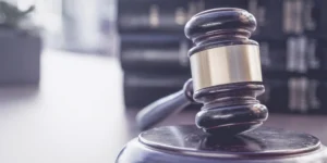 A wooden gavel and a stack of legal books.