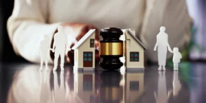 A lawyer dividing a puzzle made to resemble a home.